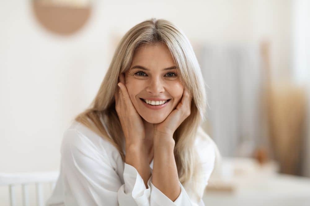 woman with smooth skin inside her house smiling